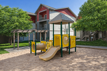 Playground with yellow play structure and tunnel slide